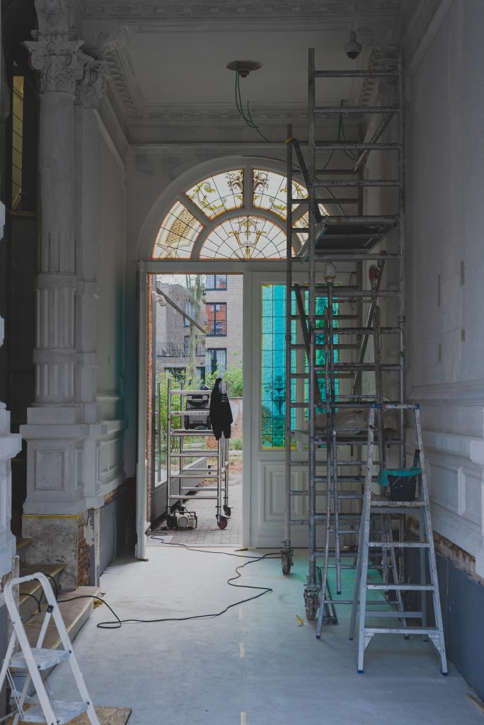 a man standing on a ladder in a room